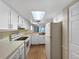 Bright kitchen featuring white cabinets, ample counter space, and modern appliances at 11485 Oakhurst Rd # A301, Largo, FL 33774