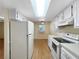 Kitchen area with plenty of storage, featuring a refrigerator and a breakfast nook at 11485 Oakhurst Rd # A301, Largo, FL 33774