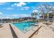 This stunning pool is surrounded by lounge chairs and tropical landscaping, perfect for relaxation at 11485 Oakhurst Rd # A301, Largo, FL 33774