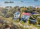 Beautiful waterfront homes, one with a red roof, the other with a blue roof, offering stunning views at 1964 Cedar Dr, Dunedin, FL 34698