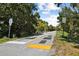 Dirt road with surrounding vegetation and speedbumps at 1964 Cedar Dr, Dunedin, FL 34698