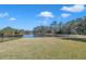 Serene backyard overlooking a tranquil pond, perfect for relaxation and enjoying nature at 20209 Merry Oak Ave, Tampa, FL 33647