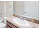 Bathroom featuring a granite countertop vanity, a white sink, chrome faucet and fixtures, and an ample mirror at 20209 Merry Oak Ave, Tampa, FL 33647