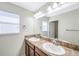 Bathroom featuring a double sink vanity with a large mirror and decorative lighting fixtures above at 20209 Merry Oak Ave, Tampa, FL 33647