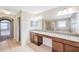 Bathroom with double vanity, granite counters, and separate tub and shower at 20209 Merry Oak Ave, Tampa, FL 33647