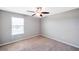 Bright bedroom features a ceiling fan, neutral walls, and a window with blinds allowing natural light in at 20209 Merry Oak Ave, Tampa, FL 33647