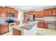 Open kitchen with an island, granite counters, stainless appliances, and wooden cabinets at 20209 Merry Oak Ave, Tampa, FL 33647