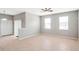 Bright living room featuring tile flooring, ceiling fan, and lots of natural light from the large windows at 20209 Merry Oak Ave, Tampa, FL 33647