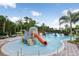Community waterpark featuring colorful splash pad with slides, a bridge, and a large swimming pool at 20209 Merry Oak Ave, Tampa, FL 33647