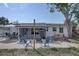 Inviting backyard featuring a screened-in porch, Adirondack chairs around a fire pit, and a spacious outdoor area at 2311 Wellesley, Bradenton, FL 34207