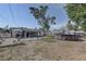 Expansive backyard showcasing a pool, storage shed, screened porch, and outdoor seating for leisure at 2311 Wellesley, Bradenton, FL 34207