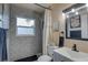 Charming bathroom with patterned tiles, a shower with a curtain, and a contemporary vanity at 2311 Wellesley, Bradenton, FL 34207