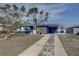 Charming home featuring blue siding, a neatly kept lawn, and a driveway leading to the entrance at 2311 Wellesley, Bradenton, FL 34207