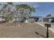 Charming home with a blue exterior, yellow door, bright sunroom, and well-maintained front yard at 2311 Wellesley, Bradenton, FL 34207