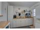 Bright kitchen with white cabinetry, butcher block countertops, and decorative backsplash tiles at 2311 Wellesley, Bradenton, FL 34207