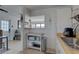 A view of a cozy kitchen featuring white cabinets and a breakfast bar that opens to the living room at 2311 Wellesley, Bradenton, FL 34207