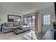 Bright living room with large windows, a comfortable sofa, and a modern mirror feature at 2311 Wellesley, Bradenton, FL 34207