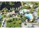Aerial view of community amenities including swimming pool, clubhouse, lake, tennis and basket ball courts at 4110 Huntingdale Ct, Wesley Chapel, FL 33543