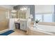 Bright bathroom offers a soaking tub, walk-in shower and vanity with neutral finishes at 4110 Huntingdale Ct, Wesley Chapel, FL 33543