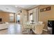 Open-concept dining area with sliding glass doors and adjacent living space at 4110 Huntingdale Ct, Wesley Chapel, FL 33543