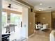 Dining room view to screened-in patio with kitchen and grill at 4110 Huntingdale Ct, Wesley Chapel, FL 33543
