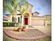 Lovely exterior showcasing a two-story home, complete with a lush lawn and attached two-car garage at 4110 Huntingdale Ct, Wesley Chapel, FL 33543