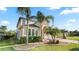 Charming two-story home with tropical landscaping, manicured lawn, and a welcoming entrance at 4110 Huntingdale Ct, Wesley Chapel, FL 33543