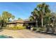 Charming exterior view of the clubhouse with lush landscaping and seating by the pool at 4110 Huntingdale Ct, Wesley Chapel, FL 33543