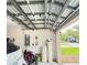 Garage featuring water softener, electrical panel, and ample storage space for vehicles and tools at 4110 Huntingdale Ct, Wesley Chapel, FL 33543