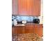 Traditional kitchen with brown cabinets, stainless steel backsplash, and granite countertops at 4110 Huntingdale Ct, Wesley Chapel, FL 33543