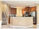Spacious kitchen with stainless appliances and a breakfast bar adjoining the staircase at 4110 Huntingdale Ct, Wesley Chapel, FL 33543