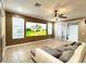 Cozy living room featuring a comfortable sectional sofa and large screen, great for movie nights at 4110 Huntingdale Ct, Wesley Chapel, FL 33543