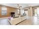 Spacious living room with tiled floors, sectional sofa and view to lanai, ideal for relaxation at 4110 Huntingdale Ct, Wesley Chapel, FL 33543