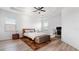 Bright main bedroom boasts a tray ceiling, ceiling fan, and an abundance of natural light at 4110 Huntingdale Ct, Wesley Chapel, FL 33543