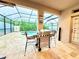 Outdoor patio and grill area overlooking screened in pool, complete with outdoor seating at 4110 Huntingdale Ct, Wesley Chapel, FL 33543
