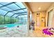 View of the pool area, featuring a hot tub, a fire pit, and outdoor cooking area at 4110 Huntingdale Ct, Wesley Chapel, FL 33543