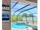 Stunning screened-in pool and spa with lush greenery visible beyond at 4110 Huntingdale Ct, Wesley Chapel, FL 33543
