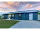 Charming single-story home with a well-maintained lawn, long driveway, and metal roof at 5108 Redwood Ter, North Port, FL 34286