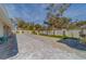 Expansive backyard featuring a paver patio, manicured lawn, and decorative landscaping at 659 Keene Rd, Largo, FL 33771