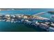 Picturesque aerial scene featuring condos by the bay, a bridge nearby, and numerous boats docked, displaying the waterfront lifestyle at 800 S Gulfview Blvd # 403, Clearwater Beach, FL 33767