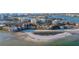 Beautiful aerial view of waterfront condos, a sandy beach, and shimmering ocean waters, showing the coastal community at 800 S Gulfview Blvd # 403, Clearwater Beach, FL 33767