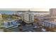 Beautiful aerial view featuring an apartment complex, bridge and beach on the background, and parking area at 800 S Gulfview Blvd # 403, Clearwater Beach, FL 33767