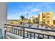 Balcony view overlooking a lively street, parking lot, and harbor at 800 S Gulfview Blvd # 403, Clearwater Beach, FL 33767
