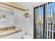 Bright bathroom with a granite vanity, a modern toilet, and a window offering scenic outdoor views at 800 S Gulfview Blvd # 403, Clearwater Beach, FL 33767