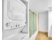 Bathroom featuring stacked washer and dryer, and a shower at 800 S Gulfview Blvd # 403, Clearwater Beach, FL 33767