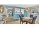Dining room with a large dining table set and view to hallway and kitchen at 800 S Gulfview Blvd # 403, Clearwater Beach, FL 33767
