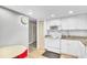 Clean kitchen with white appliances, granite countertops, and tile flooring at 800 S Gulfview Blvd # 403, Clearwater Beach, FL 33767