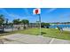 Outdoor basketball court near a lake, set within a fenced-in area and grassy surroundings at 8326 Fantasia Park Way, Riverview, FL 33578