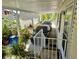 Carport with two parked cars and vibrant plants at 8326 Fantasia Park Way, Riverview, FL 33578