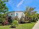 Charming home with well-maintained lawn, lush flower beds, and a decorative sunburst accent at 8326 Fantasia Park Way, Riverview, FL 33578